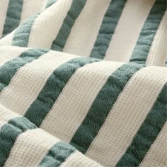 a close up view of a green and white striped blanket