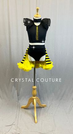 a mannequin wearing a yellow and black dress with sequins on it