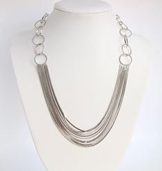 This necklace is a simple design that goes with everything. It is made of a silver loop and string, which makes it lightweight and easy to wear. The loop is large enough to fit over your head, and the string is adjustable to fit any neck size. Cheap Double Strand Chain Jewelry, Chic Multi-strand Silver Necklaces, Chic Silver Multi-strand Necklaces, Chic Silver Multi-strand Jewelry, Modern Multi-strand Silver Jewelry, Modern Silver Multi-strand Jewelry, Double Strand Necklace With Silver Chain, Multi-strand Chain Long Necklace, Double Strand Silver Chain Necklace