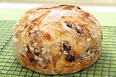 a loaf of bread sitting on top of a cooling rack