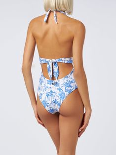 This elegant one-piece swimsuit showcases a deep V neckline both at the front and back, in a pure Marylin style, complemented by a wide-tone belt that accentuates the waist. It features broad straps and offers regular coverage at the bottomWoman one-piece swimsuitLow cut necklineUnderbust bandBroad strapsNormal bottom coverageToile de jouy all over printComposition: 90% polyamide 10% elastaneModel is 176 cm and wears a size S White Printed Beachwear One-piece, White Floral Print One-piece Swimsuit, White Floral Print Tie-side Swimwear, White One-piece Swimwear With Tropical Print, White Printed V-neck Swimwear, Saint Barth, Costume Intero, Zegna Shoes, Prada Leather