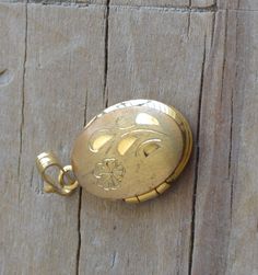 "This small locket has general is in excellent condition. It closes securely and is almost ~5/8\" long including bail. Item is sold as-is. We welcome haggling in this shop!" Antique Gold Locket Necklace Stamped 14k, Gold Locket Necklace With Vintage Charm, Gold Pendant Locket Necklace With Vintage Charm, Victorian Locket Necklace Stamped 14k, Vintage Gold Locket Necklace Stamped 14k, Gold Etched Victorian Locket Necklace, Antique 14k Stamped Locket Necklace Collectible, Antique Gold Hallmarked Locket Necklace, Gold Heirloom Locket Necklace With Antique Finish