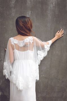 Handmade romantic bridal cape by yours truly. This bridal cape can be worn as many styles as you wish Length : Front length 32 cm/ 16 in Back length 60 cm/ 24 in Color : Light ivory Materials : tulle, French lace Shop other BRIDAL CAPES here : http://etsy.me/2zd6PZj Turnaround time: Due to the delicate nature of the handcrafted goods we produce this cover up has creation time of approximately 8-12 days Estimated shipping times: North America: 8-20 business days Europe: 8-20 business days Austral White Lace Trim Gown For Bridal Shower, White Gown With Lace Trim For Bridal Shower, White Wedding Dress With Lace Sleeves For Bride, White Wedding Dress With Lace Sleeves, Wedding Lace Shawl With Lace Trim, White Lace Trim Wedding Dress For Bridal Shower, White Wedding Dress With Lace Trim For Bridal Shower, White Bridesmaid Wedding Dress With Lace Sleeves, White Bridesmaid Dress With Lace Sleeves