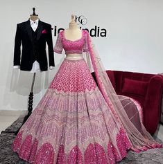 a mannequin with a pink and gold dress on display