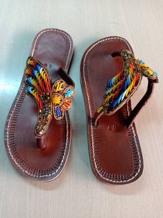 African beaded sandals, summer sandals, leather sandals, women sandals, gift for her, maasai beaded sandals. 100% handcrafted using maasai beads, Perfect christmas gift for her. All sizes are available as we custom make them. For perfect fitting kindly use the last image as a guide. Ships via dhl expressa Traditional Leather Flip Flops For Summer, Leather Open Toe Flip Flops For Festivals, Beaded Leather Sandals For Festivals, Traditional Open Toe Flip Flops For Festivals, Traditional Leather Flip Flops For Festivals, Festival Leather Sandals With Beaded Details, Leather Beaded Sandals For Festival, Traditional Leather Sandals For Summer, Leather Sandals For Festivals