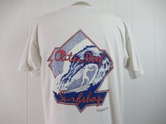 "Vintage 1980s t-shirt. Made of white cotton with two sided surfing graphics. Says: Outer Reef Surf Shop Carlsbad, Ca. Made by Hanes. Size XL. Actual measurements are: 44\" around the chest 44\" around the waist 20\" shoulder seam to shoulder seam 29\" overall length In good condition." Surf T Shirts, Carlsbad California, Surf Tshirt, Surf Shop, Vintage Tshirts, Vintage Clothing, White Cotton, Vintage Shops, Vintage Outfits