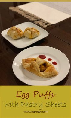 an egg puffs with pastry sheets on two white plates sitting on a wooden table