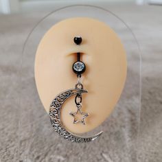 This large size dangle moon with star belly ring is sure to turn heads. Belly ring measures 3 inches long! 14g  bar length: 3/8" Not quite what you're looking for?  Click here to see our other goth belly rings: https://www.etsy.com/shop/TikiTorchDesigns?ref=seller-platform-mcnav&search_query=goth+belly **Great gift for yourself or a friend!  Choose the gift message option when you check out if you want me to include a FREE gift bag.** Grunge Alt Punk Witchy Goth Celestial Aesthetics Alt Grunge, Witchy Goth, Big Moon, Unique Women, Grunge Punk, Jewelry Black, Belly Ring, Body Jewellery, Belly Rings