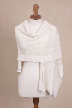 Peruvian artisan Cristina Villalobos designs a warm white shawl that combines the luxurious softness and warmth of alpaca with the resilience of acrylic and wool fibers. Knit in an eyelet pattern interspersed with three bands of cable pattern, the shawl has a lovely relaxed drape, and is wide enough to be worn either as a wrap or across the shoulders like a cape. Traditional White Scarves For Winter, Traditional White Winter Scarves, Elegant Hand Knitted Alpaca Shawl, Hand Knitted Alpaca Shawl, Knitted Alpaca Shawl, Knitted Alpaca Shawl Scarf, White Knitted Scarf For Fall, White Bohemian Winter Shawl, Elegant Alpaca Shawl One Size