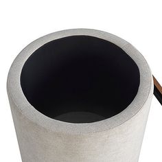 a white and black trash can sitting on top of a table