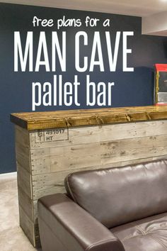 a couch sitting in front of a bar with a man cave sign on the wall