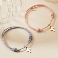 Our Mini Cross Charm Bracelet makes a colorful yet meaningful gift for a Christening or Communion. Each bracelet features a delicate mini cross paired alongside your choice of 20 colorful braids to truly capture their personality.&nbsp;18K Champagne Gold Plated and 925 Sterling SilverMini Cross: 0.3 x 0.2Braid made of a durable, colourfast polyesterFully adjustable sliding knot fasteningSent with love in a complimentary gift boxChildren’s Warning: please note, this piece of jewelry is not a toy. We advise you to not leave your child unattended when wearing their special piece as small and delicate charms can be a choking hazard if ingested. Mini Cross, Sliding Knot, Cross Bracelet, Cross Charms, Champagne Gold, Meaningful Gifts, Bracelet Making, Christening, Personalized Jewelry