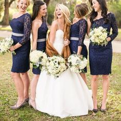 the bride and her bridesmaids are laughing together in front of some large trees