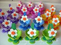 colorful paper flowers sitting on top of each other in front of a white countertop