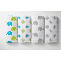 four baby swaddles are lined up on a white wall with elephants and squares