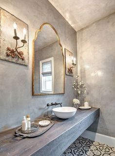 a bathroom with two sinks and a large mirror on the wall next to it's counter