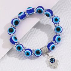 The Evil Eye & Hamsa Hand Are Both Protective Symbols Used Across Various Cultures, Especially In The Middle East, Mediterranean & North Africa Here's How They Differ And Relate: Evil Eye Meaning-The Evil Eye Is Both The Curse And The Amulet That Protects Against It. The Curse Is Believed To Be Caused By Envy Or Malevolent Looks, And Those Who Receive It May Experience Bad Luck Or Misfortune. The Amulet, Typically Depicted As A Blue Or Glass Eye, Is Worn To Protect The Wearer From This Negative Evil Eye Bracelet Every Color, Black Evil Eye Bracelet Meaning, Trendy Evil Eye Bracelets, Cleansing Evil Eye Bracelet, Eveil Eye Sead Bead Bracelet, Trendy Bracelets Evil Eye, Evil Eye Bracelets Pics, Evil Eue Bracelets, Evil Eye Bracelet Kits