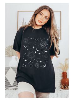 "Celestial Comfort colors t shirt in indie boho aesthetic with moon phases and stars. Comfort Colors garment-dyed t-shirt. The soft-washed, garment-dyed fabric brings extra coziness to your wardrobe while the relaxed fit makes it an excellent daily choice. The double-needle stitching throughout the tee makes it highly durable while the lack of side-seams helps the shirt retain its tubular shape. .: 100% ring-spun cotton .: Medium fabric (6.1 oz/yd² (206.8 g/m .: Relaxed fit .: Sewn-in twill label ** CARE INSTRUCTIONS ** -Machine wash: cold (max 30C or 90F); Do not bleach; Tumble dry: low heat; Iron, steam or dry: low heat; Do not dryclean. Unisex SIZING Chart:       S           M    L             XL           2XL        3XL Width,  in18.2520.2522.0024.0026.0027.40 Length, in26.6228.0029.37 Celestial Short Sleeve Cotton Tops, Celestial Cotton Tops For Summer, Celestial Style Cotton Tops With Short Sleeves, Celestial Short Sleeve Tops With Moon Print, Black Moon Print Top For Festivals, Casual Moon Print Tops For Festival, Bohemian Moon Print Cotton Tops, Bohemian Summer Tops With Moon Print, Cotton Tops With Moon Print For Festival