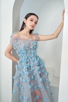 When you wearing this dress, with spread-out form and handcrafted floral you will feel like wearing a clear sky full of tenderness. Note:*Processing time takes 5-7 working days (NOT including shipping time).**The product can be customized according to measurements (bust,waist,hip) with an extra fee of 25% of the product value. Please contact support@meanblvd.com or send us a direct message on our fanpage for further assistance. Product Details - Product type: Midi Dress- Material: Organza- Asymm Light Blue Floral Print Wedding Dress, Feminine Wedding Dress With Asymmetrical Neckline, Spring Evening Organza Midi Dress, Ethereal Sleeveless Party Dress, Feminine Blue Dress For Wedding Guest, Light Blue Evening Dress For Spring, Spring Evening Dress With Asymmetrical Neckline For Wedding Guest, Ethereal Evening Dresses For Spring, Ethereal Evening Spring Dresses