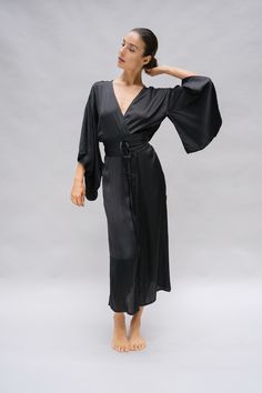 The Nerine Robe is an elegant wardrobe essential, showcasing an artful drape and dramatic sleeves. A tie waist belt accentuates your silhouette and the absence of belt loops allow for a versatile kimono jacket option. The Nerine robe is an elevated choice for morning and evening rituals, as well as any moment in between, whether you're at home or in a faraway destination. Chic Wrap Kimono For Daywear, Elegant Brunch Dress With Belted Cuffs, Chic Silk Wrap Robe, Fitted Formal Robe For Spring, Elegant Fitted Wrap Robe, Chic Silk Robe With Kimono Sleeves, Fitted Wrap Robe, Chic Long Sleeve Kimono With Tie Waist, Elegant Spring Kimono For Workwear