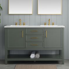 two mirrors are above the double sink vanity in this gray bathroom with gold trimmings