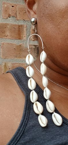 So cute and natural  Chunky handmade Grapevine design  Wood beads and authentic cowrie shells These are lightweight  Hang 5 inches  Handmade original design clip on style Handmade Cowrie Shell Earrings For Beach, Handmade Cowrie Shell Earrings For Vacation, White Shell-shaped Cowrie Shell Earrings, White Cowrie Shell Earrings, Handmade Dangle Shell For Summer, Bohemian White Cowrie Shell Earrings, Handmade Bohemian Cowrie Shell, Bohemian Handmade Cowrie Shell, Bohemian Adjustable Dangle Shell