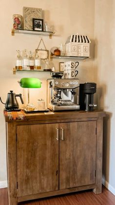 a coffee machine sitting on top of a wooden cabinet