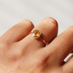 This ring with beautiful Natural Yellow sapphires, is set in 14 K Solid Gold. It is a ring perfect for any gifting occasion for your loved ones. Purchase the perfect gift for your mom, wife, daughter, girlfriend, and fiancee. This ring, due to its design, can also be stacked easily with other rings. -Material - 18K Solid Yellow Gold -Gemstone - Natural Yellow Sapphire -Gemstone weight - 2.190 ct -Gross weight - 2.4 grams Yellow Sapphire stone unites lovers who are separated. The wearer of yellow 14k Gold Yellow Sapphire Ring, Oval Yellow Sapphire Diamond Ring, Fine Jewelry Yellow Sapphire Round Ring, Yellow Sapphire Oval Ring In Fine Jewelry Style, Yellow Sapphire Oval Promise Ring, Oval Yellow Sapphire Promise Ring, Gold Sapphire Promise Ring With Faceted Detail, Faceted Yellow Gold Sapphire Ring, Gift Yellow Sapphire Birthstone Ring