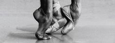 a black and white photo of a ballerina's feet