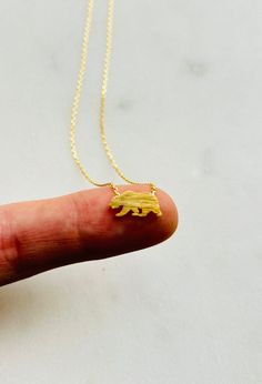 "Celebrate your love for the Golden State with this stunning California Bear Pendant Necklace. Crafted with 18k gold dipping, this pendant features a finely detailed bear emblem that hangs from a delicate 16 inch chain. The bear represents strength, resilience, and freedom, making this necklace a great gift for anyone who is proud to call California their home or simply has a passion for the state's iconic symbol. The gold dipping ensures a beautiful and durable finish that will not fade or tarn Tarnish Resistant Recycled Gold Charm Necklaces As Gift, Tarnish Resistant Recycled Gold Charm Necklace As Gift, Tiny Gold Minimalist Charm Necklaces, Gold Delicate Minimalist Charm Necklaces, Minimalist Pendant Jewelry For Best Friend Gift, Minimalist Nickel-free Necklace For Best Friend, Minimalist Nickel Free Necklace For Best Friend, Minimalist Recycled Gold Necklace As Gift, Minimalist Recycled Gold Necklace For Gift