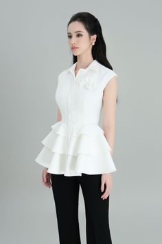 The shirt proves its charm when transforming impressively on a classic white tone. Designed with a novelty wavy peplum style that accentuates the overall costume and makes it more eye-catching and feminity. Note:*Processing time takes 13-17 working days (including 10-15 working days for manufacturing and NOT including shipping time)**Made To Order Definition:- The product is currently unavailable and not in mass production.- The product will be manufactured immediately after its order has been p Formal Summer Peplum Top, White Peplum Blouse With Ruffles, Chic White Peplum Blouse, White Ruffled Peplum Blouse, Classic White Tops For Party, White Ruffled Evening Top, Classic White Party Tops, Classic White Party Top, Elegant White Ruffled Tops