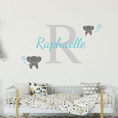 a baby's room with a crib and wall decal that says r