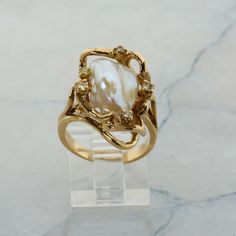 14K Yellow Gold Pearl and Diamond Ring, interesting asymmetrical design, Ring size 6.5, 8.7 grams Stock # R00070 This listing contains photographs of the actual item you will receive.  Our items are in excellent condition with little or no signs of wear and many are one of a kind pre-owned estate finds.   Please look closely at the pictures in this listing as they are part of the product description. Please read the description, as any imperfections or condition comments will be included.  We do our best to accurately describe the condition of each piece and encourage you to ask questions prior to purchase.    We are happy to address any questions you may have.  Please contact us.  Our Store has many other items for sale.  We specialize in fine & designer jewelry, watches & more.    Coloni Inlaid Engagement Rings, Pearl And Gold Jewelry Aesthetic, Pearl And Moissanite Ring, Vintage Italian Engagement Rings, Antique Engagement Rings Vintage 1920s Gold, Art Nouveau Engagement Ring Antique, Gold Pearl Wedding Ring, Gold Jewelry Pearl, Gold Engagement Ring With Silver Band