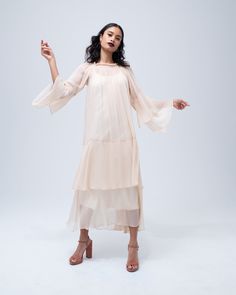 This effortless silk chiffon dress features a romantic double layer cascade in the bodice and sleeve, and a stretch oval neckline that can be worn over the shoulder. Wear it loose as a whimsical party dress, or belt it for a sleek cocktail look. Handmade in New York. 100% silk chiffon Model is wearing a size S and is 5'10" Product Care: Dry Clean Only Cascade Dress, Whimsical Party, Cocktail Look, Tie Waist Maxi Dress, Artisan Fashion, Silk Chiffon Dress, Rayon Dress, Luxury Dress, Dress Cuts