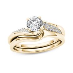 a yellow gold wedding ring set with a round diamond center and two rows of diamonds on each band