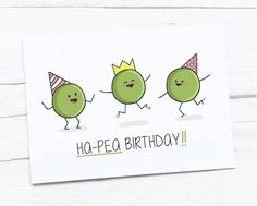 three peas wearing party hats and one has a happy birthday card in front of them