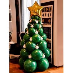 a christmas tree made out of green balloons