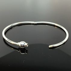 "This sterling silver Eternity Bangle is hinged to easily slip on the wrist. It features a threaded bead which completes the circle of eternity. The bangle can accommodate medium and large spacer beads, European style charm-beads, and traditional charms. Available in both sterling silver, and sterling silver with 14k gold vermeil. \"Sterling\" is inscribed on the inside of the band. Available in extra small, small, medium, and large. Extra small tends to fit a preschool girl or boy. Extra Small Sterling Silver Bangle With Lobster Clasp, Adjustable Sterling Silver Bracelet With Clasp, Adjustable Sterling Silver Bracelet With Box Clasp, Adjustable Bangle Bracelet With Box Clasp, Adjustable Bangle Bracelets With Box Clasp, Adjustable Silver Bracelet With Clasp, Silver Bangle Bracelet With Clasp, Flamingo Necklace, Modern Bracelet