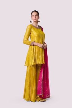 Keep it stylish on special occasions in this stunning yellow embroidered organza sharara suit. It comes with a pink dupatta. Shop online from Pure Elegance. Disclaimer: The actual product may vary slightly from the image. These are custom orders, hence expect slight variation in color and placement of the motif or buta. ESTIMATED DELIVERYBecause this is a custom order, it would take about 4 weeks from the date of purchase. RETURN POLICYThis product is a custom order and cannot be returned or exchanged. Festive Yellow Palazzo Set With Mirror Work, Yellow Chinon Palazzo Set For Festivals, Yellow Chinon Palazzo Set For Festive Season, Festive Yellow Chinon Palazzo Set, Designer Yellow Sharara With Dupatta, Yellow Palazzo Set With Zari Work, Yellow Palazzo Set With Zari Work For Eid, Yellow Anarkali Palazzo Set For Eid, Yellow Semi-stitched Sharara For Eid