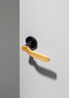 an open door with a wooden handle on the left side and a black knob on the right