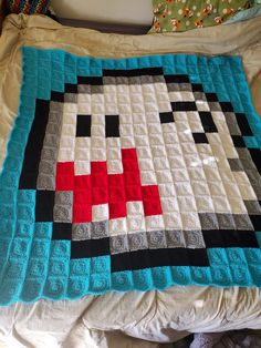 a bed with a blanket made to look like an old school computer game character on it