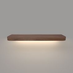 a wooden shelf with lights above it