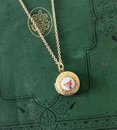 A beautiful and dainty vintage brass locket on an adjustable length chain. The locket is from the mid 20th century and is new-old stock (meaning it was made in the mid century, but never used). It features a lovely engraved pattern on the edge. I have added a guilloche hand painted enameled rose in the center, which is also new old stock from the 1960s.  The sturdy brand new chain is 14K gold plated brass. It has 3 links to hook the lobster claw clasp in, so that the chain can easily be shortene Tiny Locket, Rose Locket, Feminine Accessories, 16 Birthday, Piercings And Tattoos, The Lobster, Sweet 16 Birthday, 16th Birthday, Locket Necklace