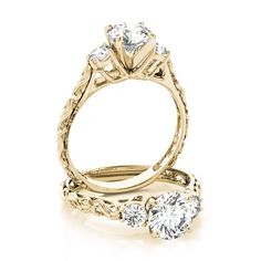 an engagement ring with three stones on the side and two diamonds in the middle, set against