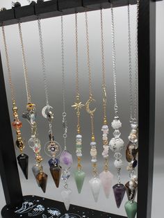 The power of personalized energy with our exquisite Custom Crystal Pendulum. Crafted with precision and intention, each pendulum is a unique masterpiece tailored to your desires. Whether you seek clarity, guidance, or alignment, this bespoke tool is designed to resonate with your energy and amplify your intentions. Our skilled artisans hand-select each crystal, ensuring the highest quality and vibrational resonance. From soothing Amethyst to empowering Tiger Eye, our wide selection of crystals allows you to choose the perfect stone that aligns with your intentions and energy. Personalize your pendulum further with Pendant or design, making it a truly one-of-a-kind treasure. Our customization options add a touch of personal magic to your pendulum. Harness the ancient wisdom of divination an Spiritual Crystal Necklace With Adjustable Chain And Dangle, Wicca Crystals, Dowsing Pendulum, Pendulum Dowsing, Crystal Pendulum, Crystal Angels, Witch Jewelry, Crystal Crafts, Handmade Fashion Jewelry