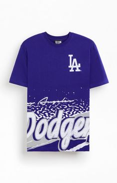 The New Era LA Dodgers Sport Class T-Shirt offers a nod to retro sports style. With a crew neckline, short sleeves, and vintage-inspired LA Dodgers graphics at both the left chest and hem, it’s a classic choice for fans of timeless design.Solid color teeShort sleevesCrew necklineLA Dodgers graphicsStandard fitMachine washable New Era Mens LA Dodgers Sport Class T-Shirt - Blue size Medium Streetwear Graphic T-shirt For Baseball Season, Collegiate Style Screen Print T-shirt For Streetwear, Blue Sublimation Print Tops For Baseball Season, Blue Graphic Tops For Baseball Season, Throwback Crew Neck Fan Merchandise Tops, Summer Throwback Tops With Graphic Print, Baseball Season Graphic Tee With Logo Print, Collegiate Streetwear T-shirt With Graphic Print, Collegiate Graphic T-shirt For Streetwear