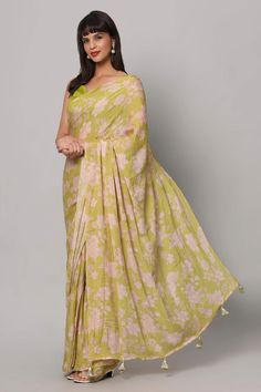 Introducing our enchanting Linda Lime Green Georgette Floral Sequins One Minute Saree – a kaleidoscope of style that's like a garden in full bloom. Imagine yourself wrapped in the vivid vibrancy of lime green georgette, adorned with delicate floral sequins that shimmer like morning dew on petals. The Ivory white cut dana tassels gracing the pallu's edges, adding a playful twist to your elegance. Completing this masterpiece is a raw silk blouse, featuring cap sleeves and a corset neckline, making Bohemian Floral Print Saree For Wedding, Bohemian Wedding Saree With Floral Print, Bohemian Floral Print Wedding Saree, Spring Green Saree With Floral Print, Bohemian Floral Print Festive Saree, Spring Green Floral Print Saree, Festive Bohemian Floral Print Saree, Green Floral Print Saree For Summer, Spring Bollywood Style Floral Saree