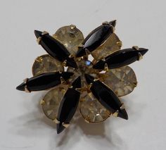 Vintage faux black onyx & rhinestone brooch. Gold tone metal brooch is 1" x 1" with a standard working fastener. Faux black onyx faceted navettes & clear round rhinestones, all of which are present and intact. Excellent condition. Vintage Black Brooch Lapel Pin, Black Brooch Jewelry For Party, Black Party Jewelry Brooch, Vintage Black Collectible Brooches, Black Formal Brooch Lapel Pin, Vintage Black Party Pins, Black Formal Lapel Brooch, Black Brooch For Formal Occasions, Black Brooch Pins For Evening