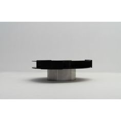 a black and silver object sitting on top of a white table