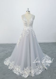 a wedding dress with white flowers on it